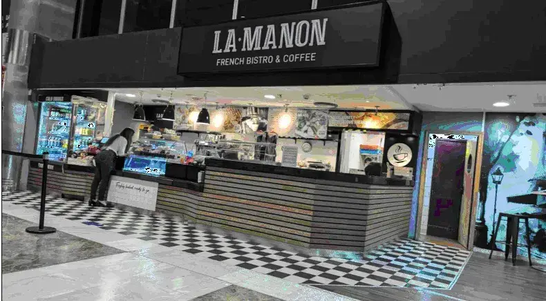If you find the La Manon Cafe, you will see the meeting stand opposite where your driver will wait