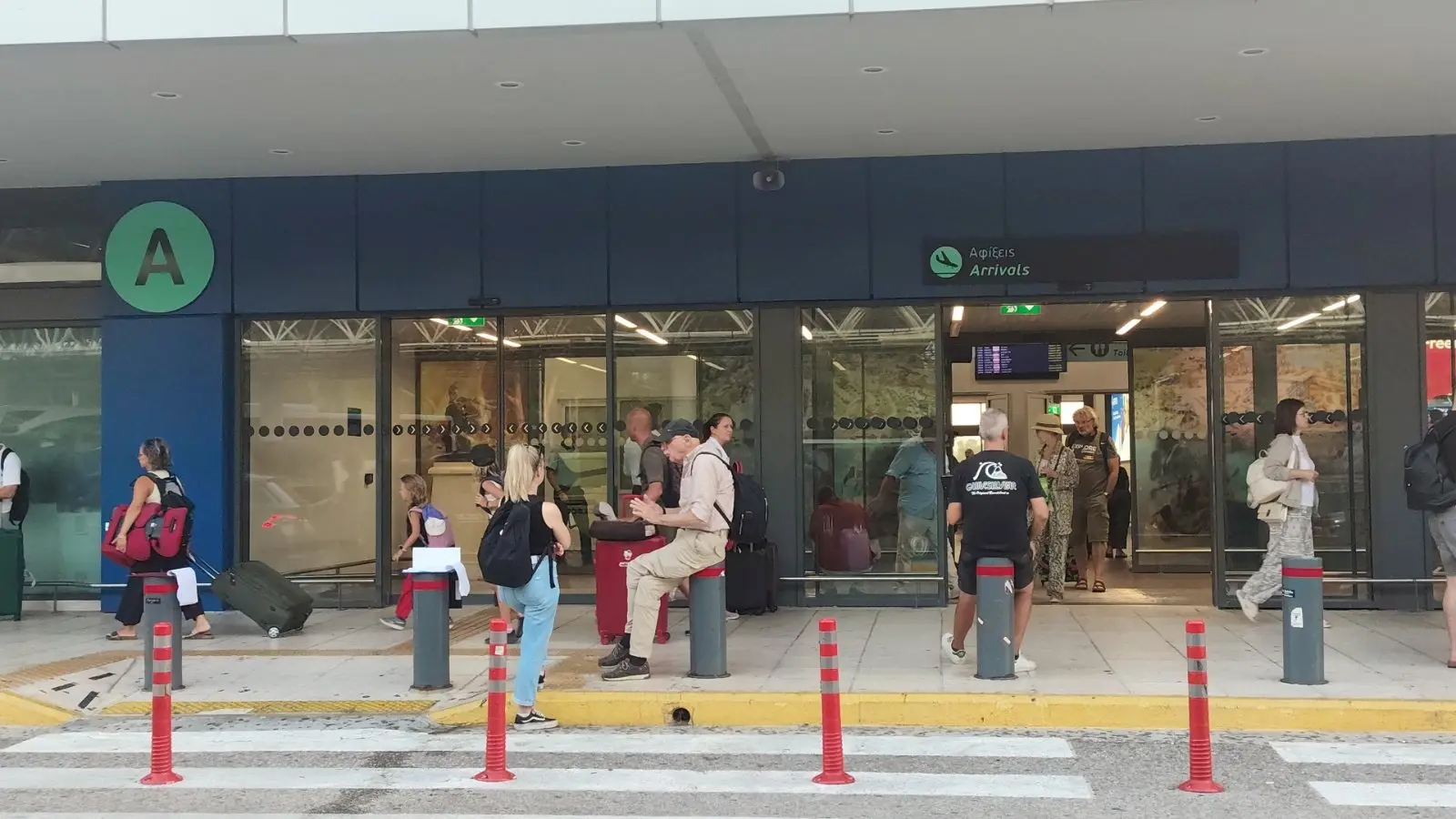Corfu airport terminal front where your drier will meet clients with names on boards