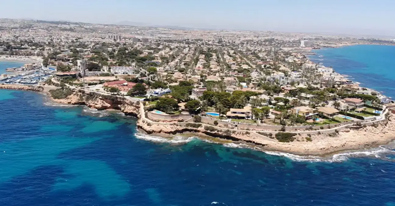 The scenic coastline and beach resort of Cabo Roig, a top destination for travelers booking private taxi services from Alicante airport.