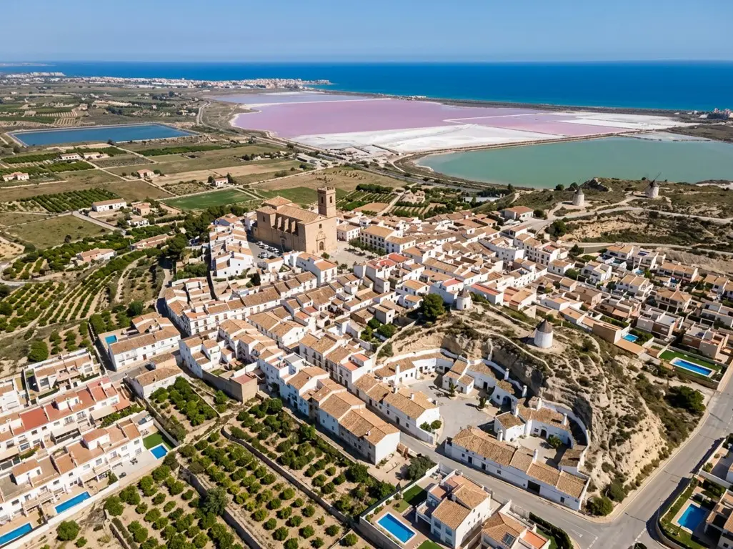 The scenic views of the pink salt lakes from San Miguel de Salinas resort town, a popular destination reached via private taxi services from Alicante airport.