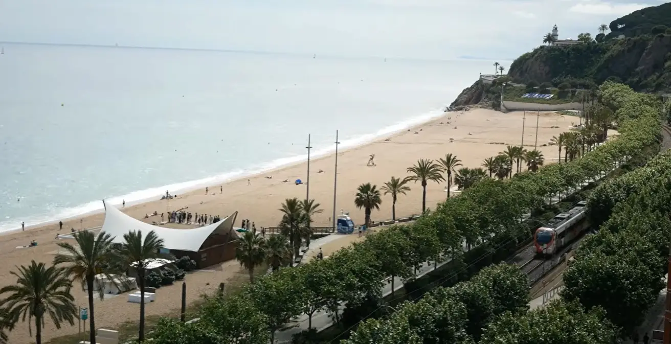 A sunny beachfront view of Calella de la Costa, the destination for Cheap Taxis private holiday transport from Girona Airport