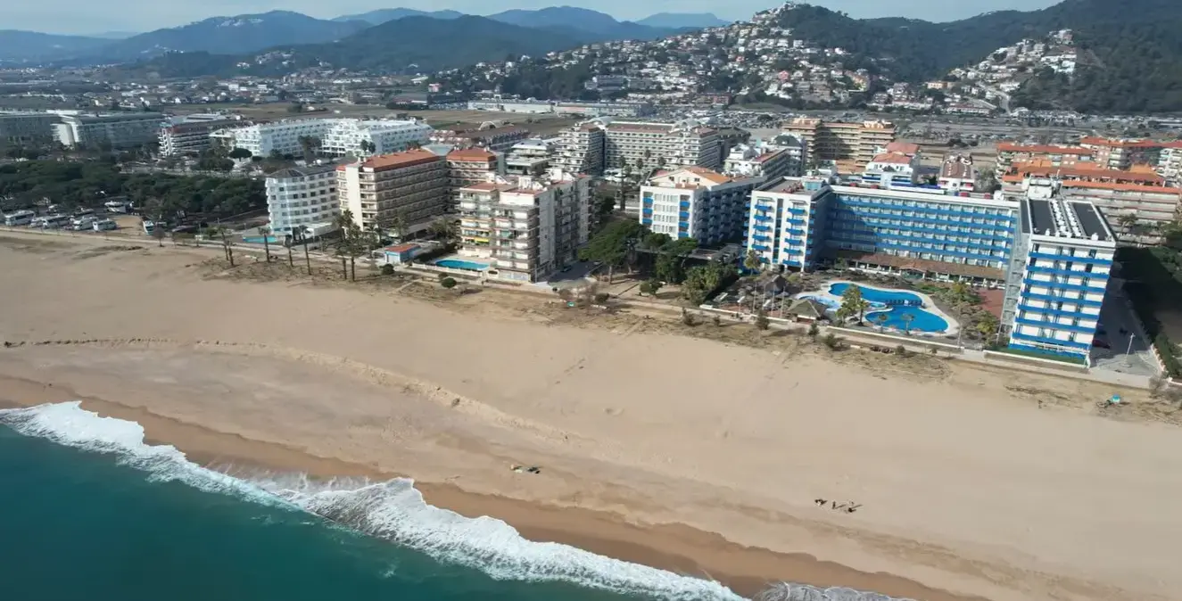 The sunny coastal promenade and beachfront of Santa Susanna, a popular family holiday resort for Cheap Taxis direct private airport transfers from Girona Airport.