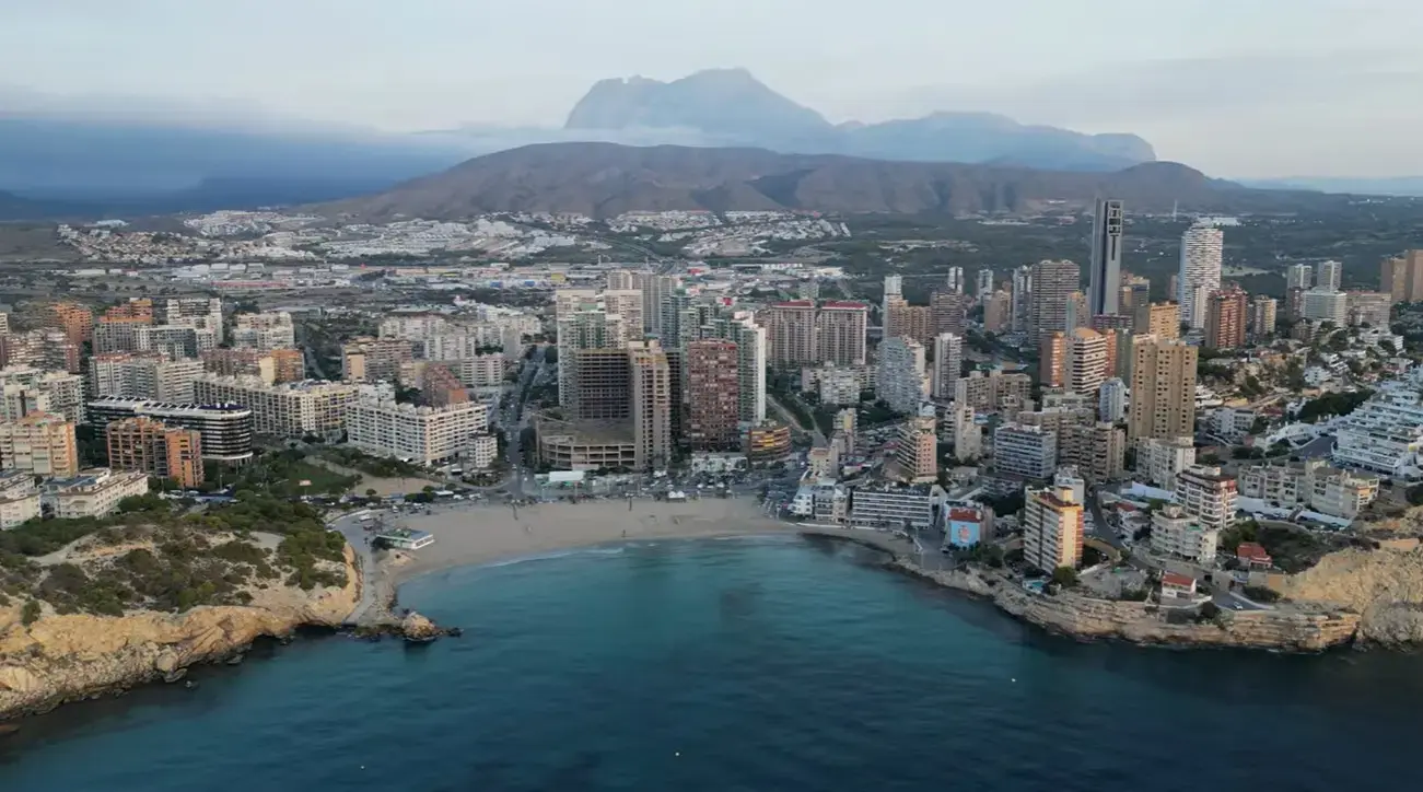 The scenic bay and sandy beach at Cala Finestrat resort, a popular holiday destination reached via private taxi services from Alicante airport.