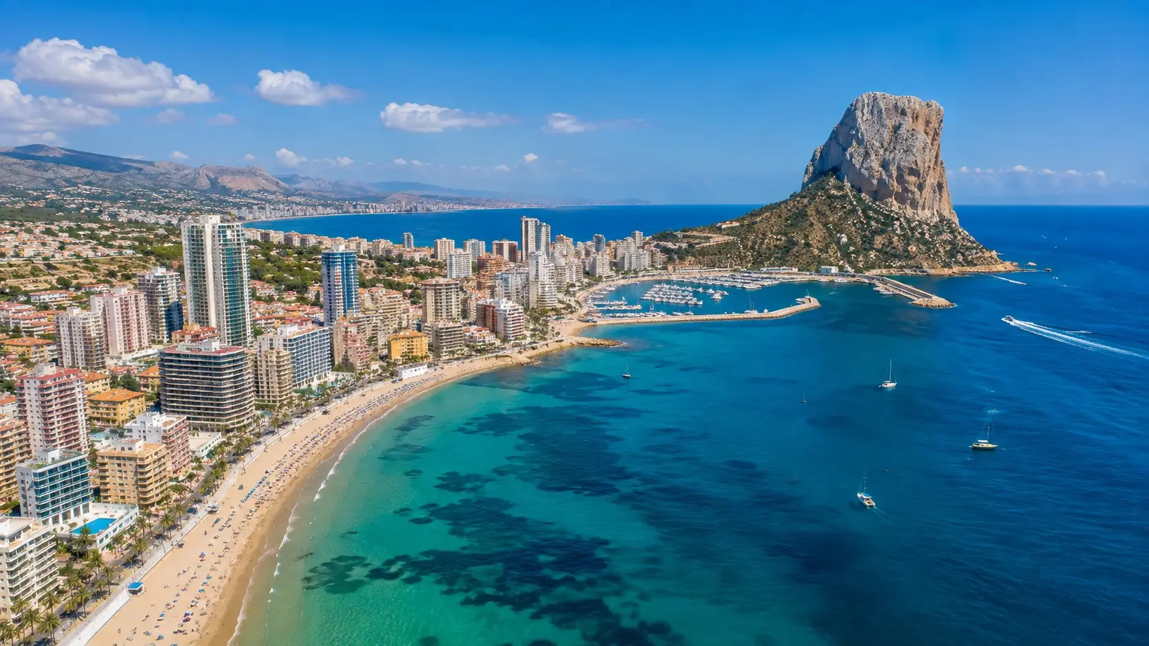 The iconic Peñon de Ifach rock overlooking Calpe resort beach, a popular destination for travelers using private taxi services from Alicante airport.