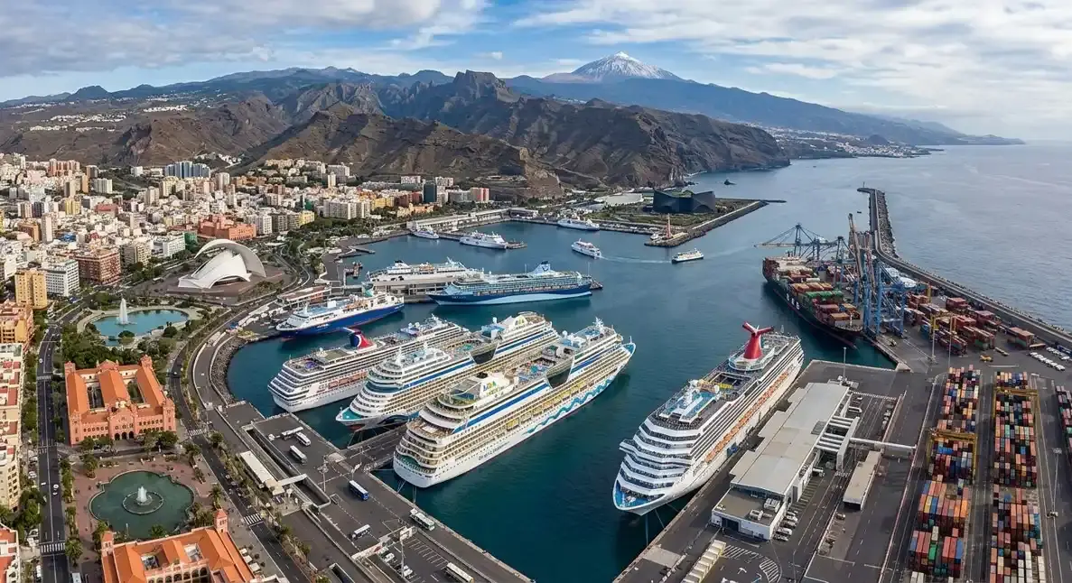 A scenic view of the bustling Santa Cruz de Tenerife cruise port terminal and ocean liners, for passengers booking an affordable private airport transfer with cash payment directly to the driver.