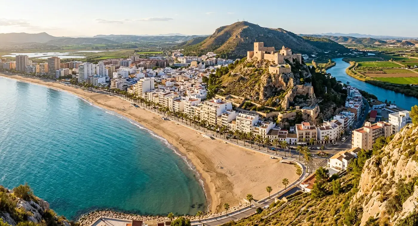 Historic hilltop castle and wide sandy bay of the coastal resort of Cullera for private taxi airport transfers from Valencia Airport by cheap-taxis.com